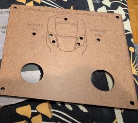 Hardboard and metal versions of the headlight control panel