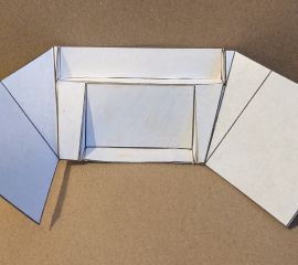 Close-up photograph of a paper-and-cardboard prototype of a train dashboard