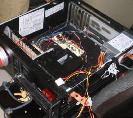 The control box for PartyMode, built in an old 1U rack server. The covered switches, from left to right, turned off the room lights, activated the sound system, and played the THX startup sound. The button would load a playlist of dance music and start playing it, while subsequent taps would change songs.